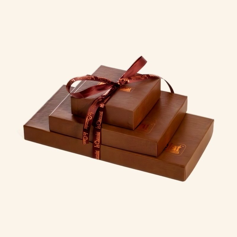 Our gift boxes, stacked, tied with a Le Chocolat ribbon